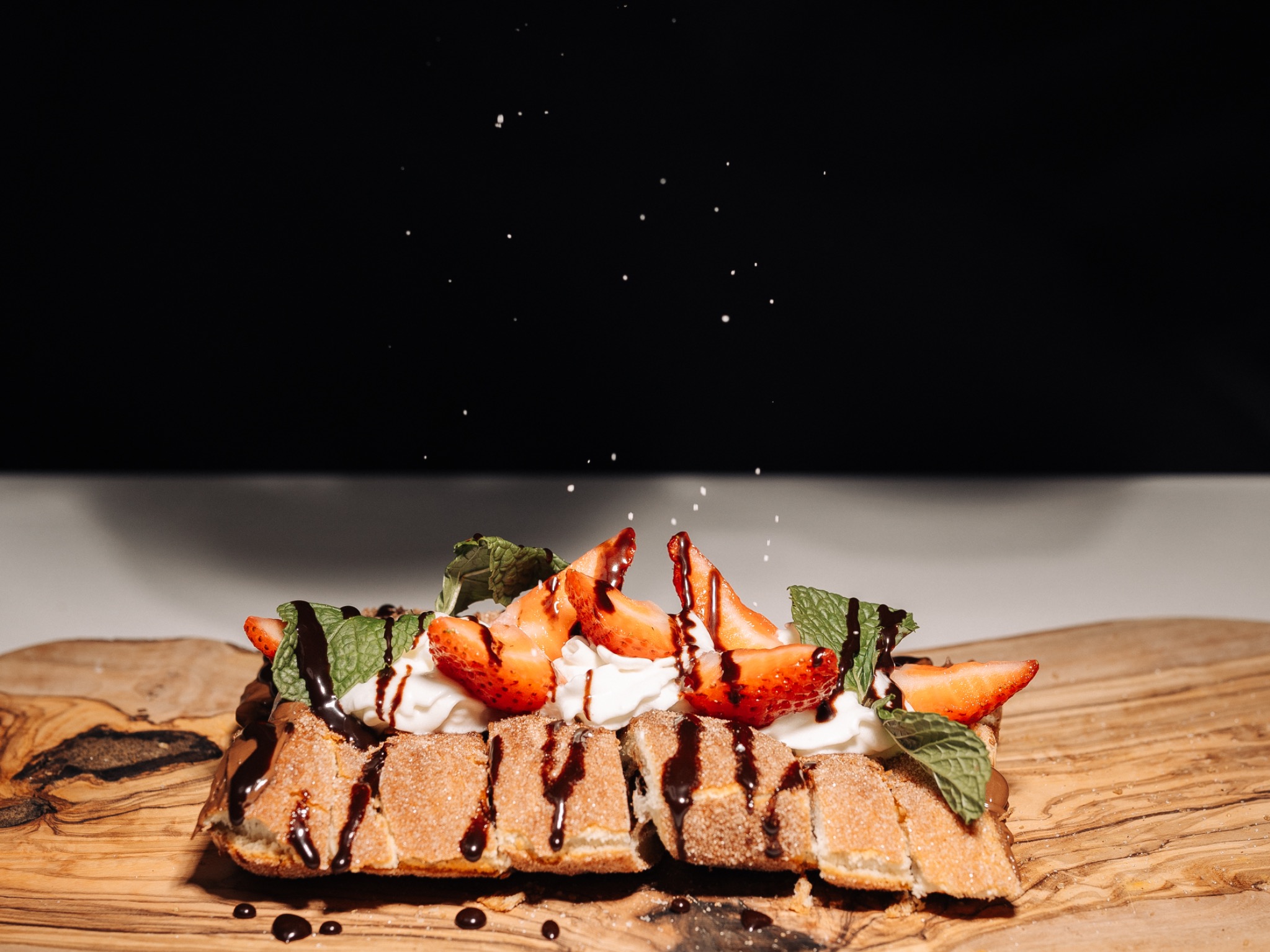 Loaded chimney cake sandwich with strawberries and cream